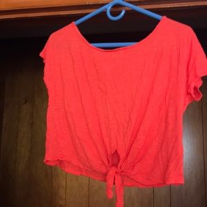 An bright orange colored crop top.